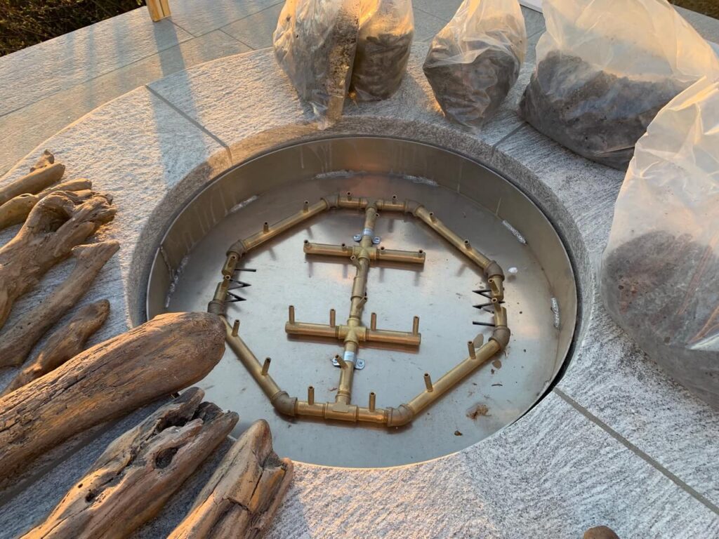 fire pit pan with burner on it