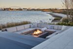 ready to finish fire pit kit with beautiful pool and patio next to a lake or ocean